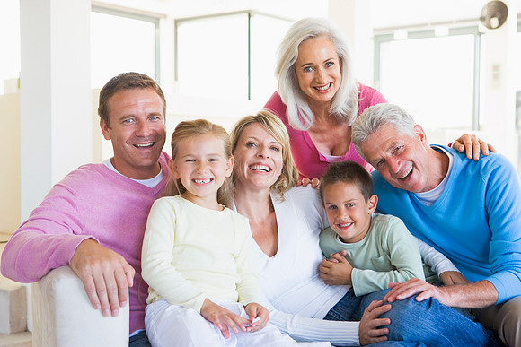 Family-Sitting-Indoors-Smiling