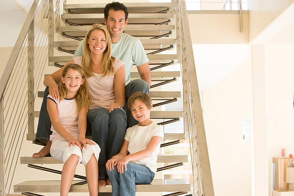 Family-Sitting-on-Staircase-Smiling